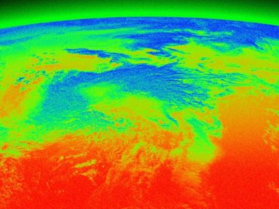 False-color image of Earth showing an atmospheric view with green, blue, and red hues indicating different temperatures and conditions.