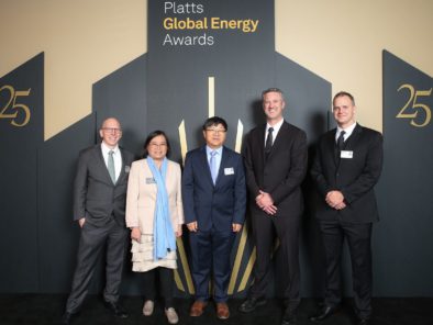 Five people stand together at the Platts Global Energy Awards event, with a backdrop featuring the number 25 and the event name.