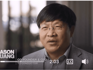 A person is speaking in a video, wearing glasses and a gray suit. The text reads "Jason Huang, Co-Founder & CEO, TS Conductor." The video duration is 2:03.